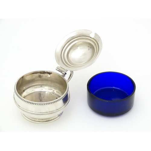 285 - A silver mustard pot with blue glass liner hallmarked Birmingham 1919 maker Collingwood & Sons Ltd. ... 