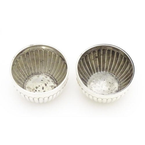 296 - A pair of Victorian silver salts with fluted decoration hallmarked Chester 1900, maker Stokes & Irel... 