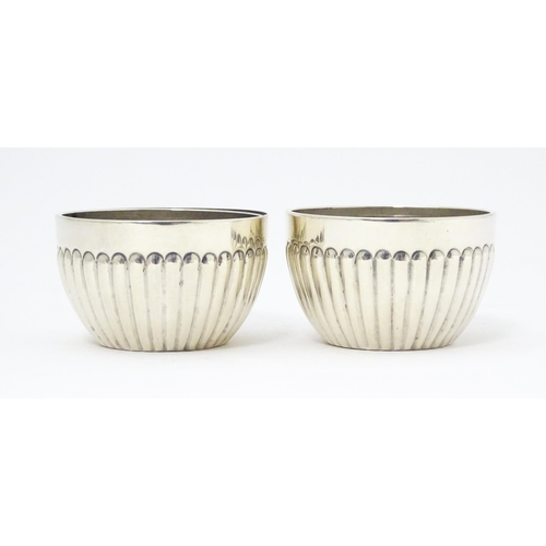 296 - A pair of Victorian silver salts with fluted decoration hallmarked Chester 1900, maker Stokes & Irel... 