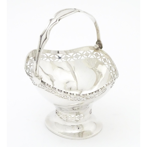 302 - A silver sugar basket with swing handle, hallmarked Birmingham 1927 maker Henry Matthews  Approx. 3 ... 