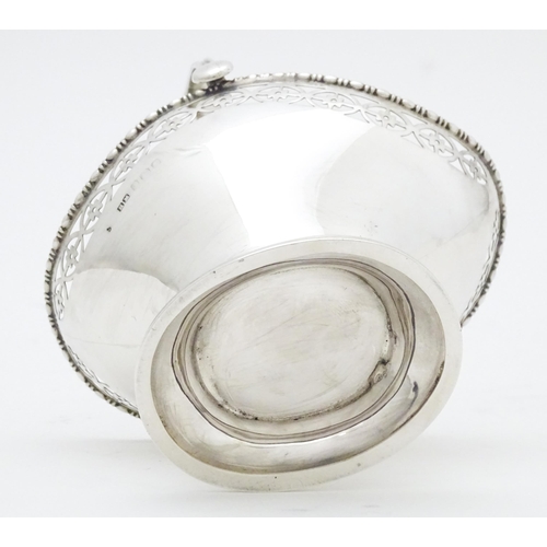 302 - A silver sugar basket with swing handle, hallmarked Birmingham 1927 maker Henry Matthews  Approx. 3 ... 