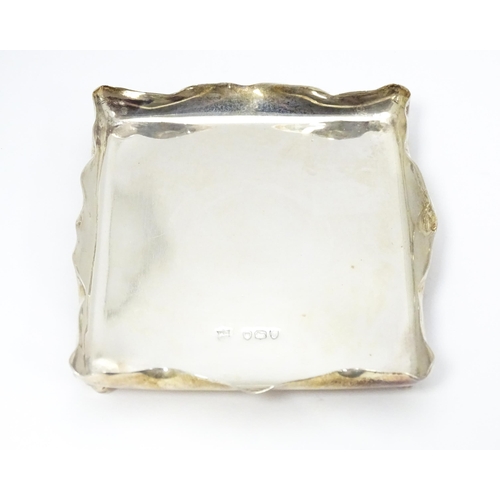 310 - A Victorian silver pin dish of rectangular form raised on four ball feet. Hallmarked London 1895 mak... 