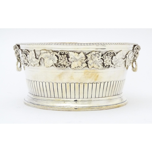 315 - A silver bowl with fruiting vine decoration and twin handles with rams head decoration. Hallmarked L... 