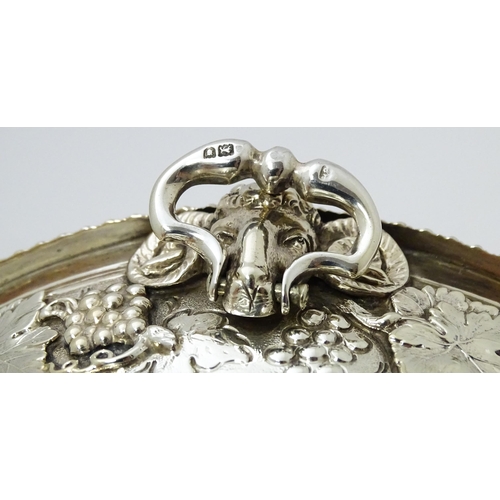 315 - A silver bowl with fruiting vine decoration and twin handles with rams head decoration. Hallmarked L... 