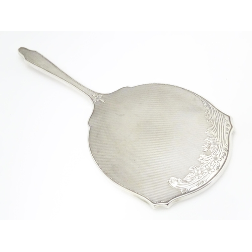 321 - A silver backed hand mirror hallmarked Birmingham 1959 maker Walker & Hall  Approx. 10 1/2