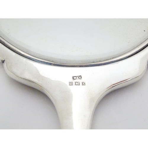 321 - A silver backed hand mirror hallmarked Birmingham 1959 maker Walker & Hall  Approx. 10 1/2