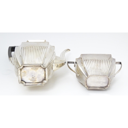 323 - A silver coffee / hot water  pot hallmarked Sheffield 1910 together with a twin handled sugar hallma... 