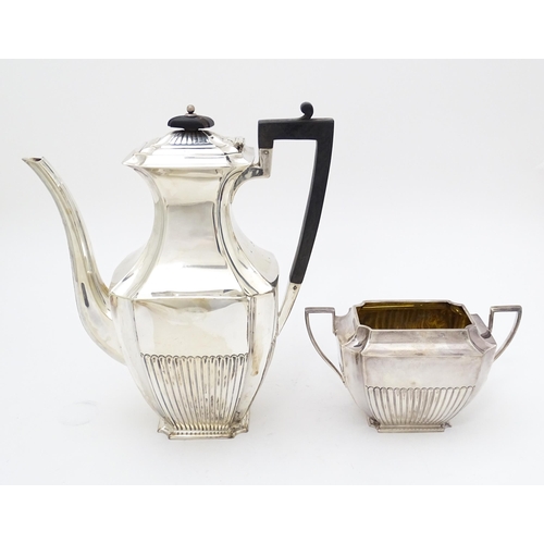 323 - A silver coffee / hot water  pot hallmarked Sheffield 1910 together with a twin handled sugar hallma... 