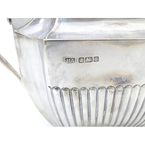 323 - A silver coffee / hot water  pot hallmarked Sheffield 1910 together with a twin handled sugar hallma... 