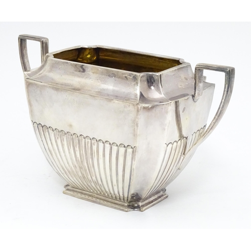 323 - A silver coffee / hot water  pot hallmarked Sheffield 1910 together with a twin handled sugar hallma... 