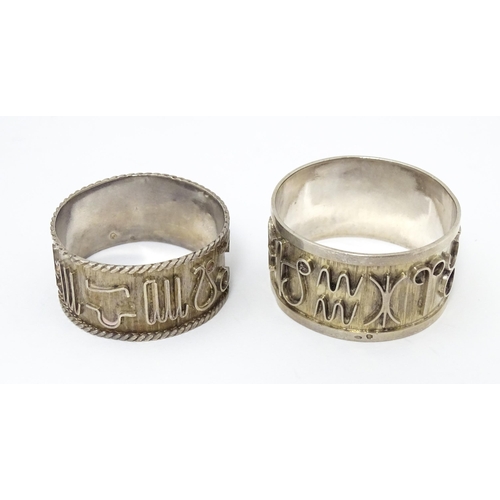 334 - Two Continental silver napkin rings  both decorated with astrological symbols. One with rope twist s... 