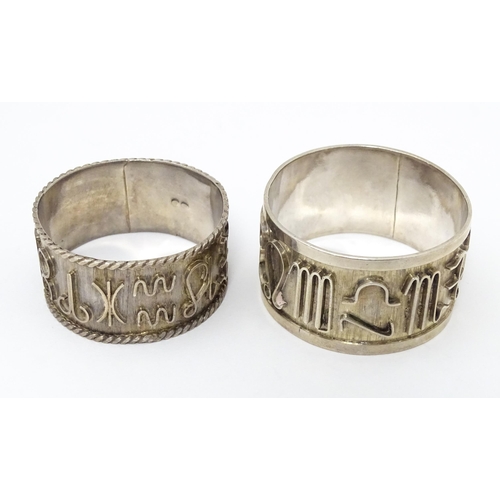 334 - Two Continental silver napkin rings  both decorated with astrological symbols. One with rope twist s... 