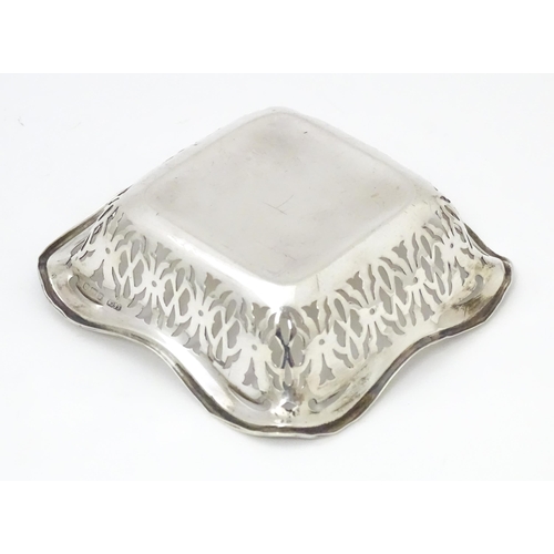 335 - A silver bonbon dish of squared form with pierced decoration, hallmarked Birmingham 1913 maker Sydne... 