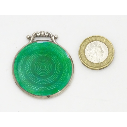 339 - A small silver mirror with green guilloche enamel decoration. Hallmarked  Birmingham 1920 maker Cris... 