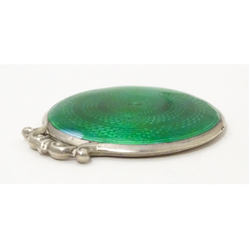 339 - A small silver mirror with green guilloche enamel decoration. Hallmarked  Birmingham 1920 maker Cris... 