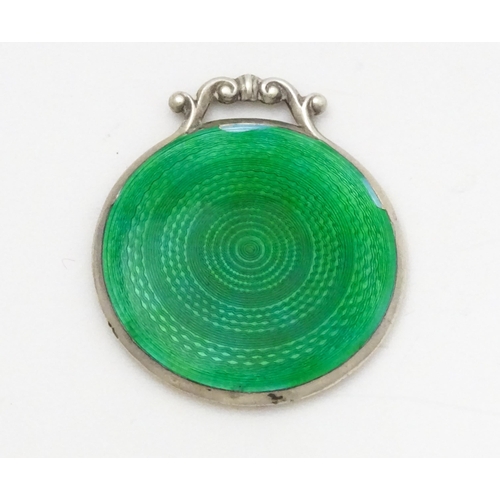 339 - A small silver mirror with green guilloche enamel decoration. Hallmarked  Birmingham 1920 maker Cris... 