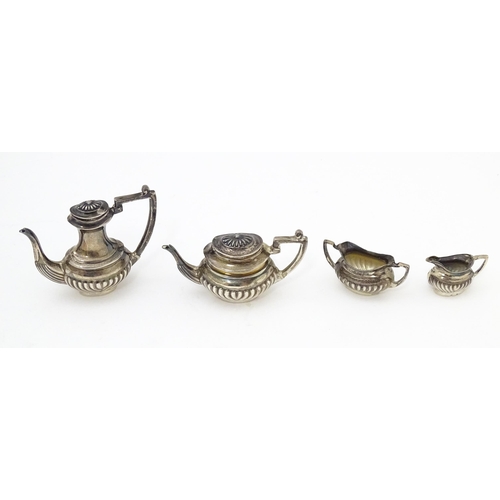 344 - A silver 5 piece miniature / dolls house tea set comprising tea pot, coffee pot, sugar bowl and crea... 