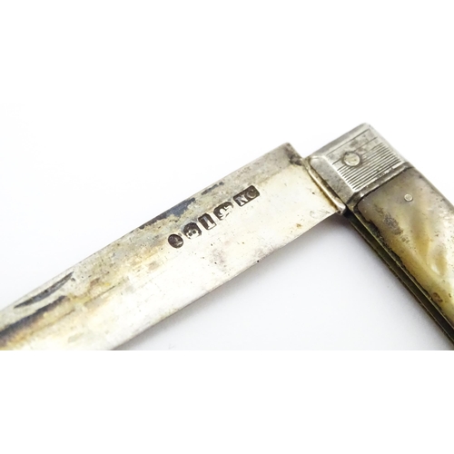 345 - A 19thC silver folding fruit knife with mother of pearl handle. Hallmarked Sheffield 1833 maker Nath... 