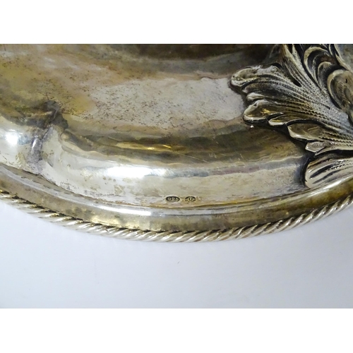 358 - A Hanau silver centrepiece bowl of lobed form with hammered finish and raised on three Georgian dolp... 