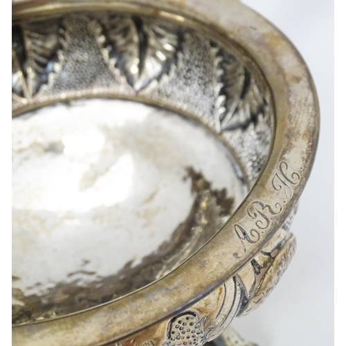 373 - A white metal brazier / ember bowl foliate detail and raised on three ball and claw feet with twin h... 