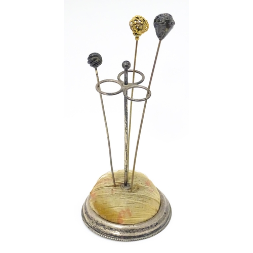 374 - An early American silver hat pin stand together with 3 hat pins. The stand marked under Sterling and... 