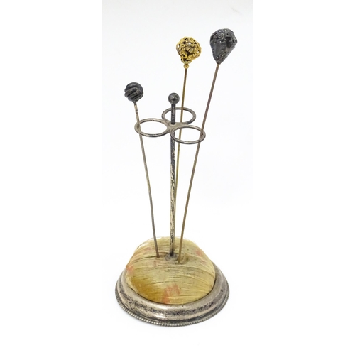 374 - An early American silver hat pin stand together with 3 hat pins. The stand marked under Sterling and... 