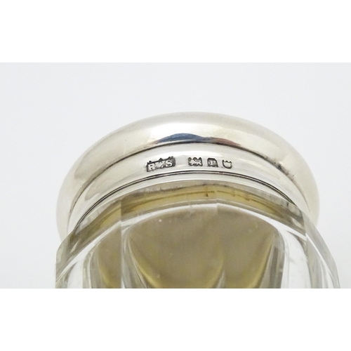 397 - A glass toilet / dressing table jar with silver lid hallmarked London 1912 maker Loebl & Co. 3 1/4