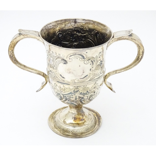 431 - A Geo III silver twin handled cup  with floral and foliate scroll decoration. Hallmarked London 1788... 