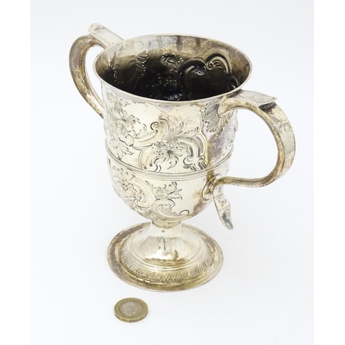 431 - A Geo III silver twin handled cup  with floral and foliate scroll decoration. Hallmarked London 1788... 