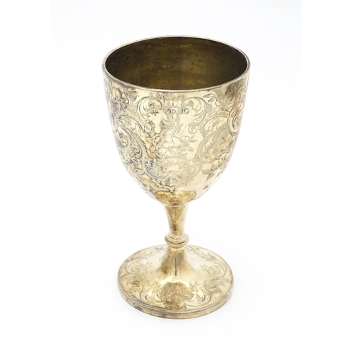 433 - A Victorian silver cup / chalice / goblet with engraved floral and scroll decoration. Hallmarked Lon... 