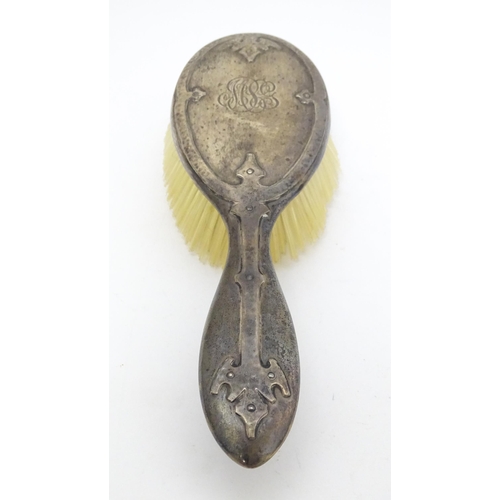 489 - Three American sterling silver backed items comprising two brushes and a hand mirror. Mirror approx.... 