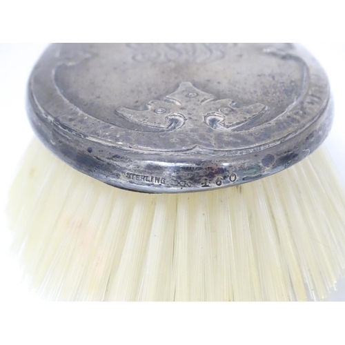 489 - Three American sterling silver backed items comprising two brushes and a hand mirror. Mirror approx.... 