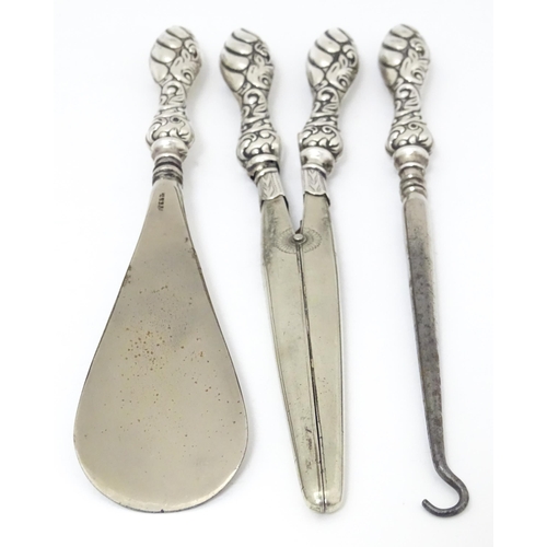 517 - Three silver handled items comprising shoe horn, button hook and glove stretches. Shoe horn approx. ... 