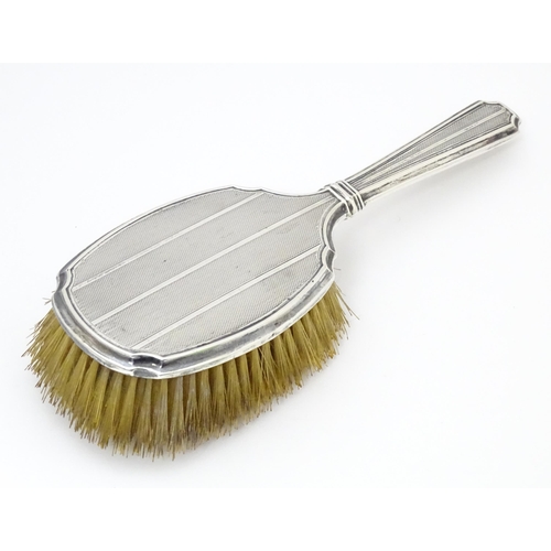 525 - An Art Deco silver backed hair brush with engine turned decoration hallmarked Birmingham 1927, maker... 