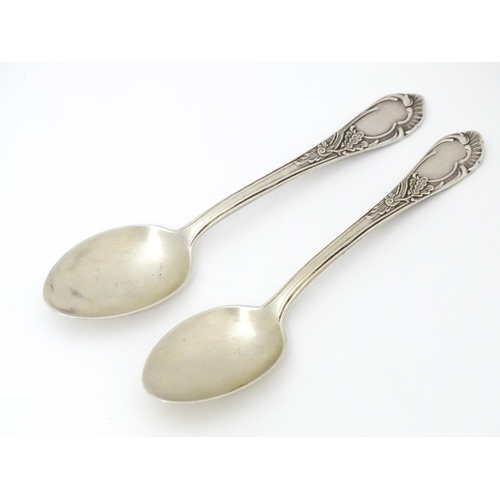 533 - Two Russian / Soviet silver teaspoons with foliate detail to handles, marked 875. Approx. 5 1/4