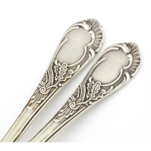 533 - Two Russian / Soviet silver teaspoons with foliate detail to handles, marked 875. Approx. 5 1/4