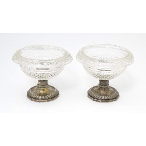 534 - A pair Continental silver and cut glass sweet meat dishes / pedestal salts. Approx. 3 1/2