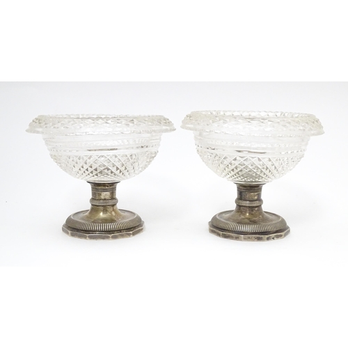 534 - A pair Continental silver and cut glass sweet meat dishes / pedestal salts. Approx. 3 1/2