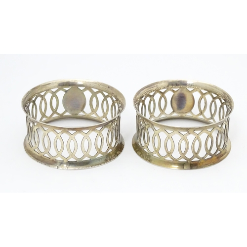 536 - A pair of silver napkin rings with openwork decoration hallmarked Chester 1912, maker M & J. Togethe... 