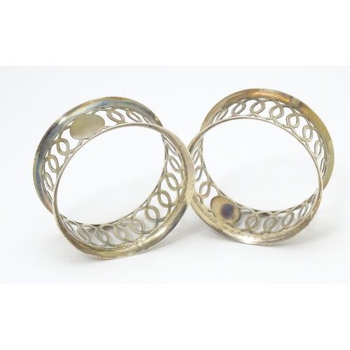 536 - A pair of silver napkin rings with openwork decoration hallmarked Chester 1912, maker M & J. Togethe... 