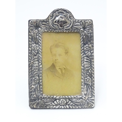 559 - An easel back photograph frame with silver surround hallmarked Birmingham 1902, maker Mitchell Bosle... 