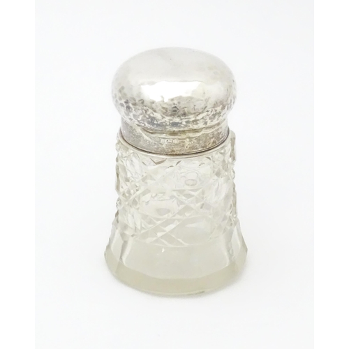 564 - A cut glass dressing table jar with hammered silver lid hallmarked Birmingham 1908, maker Walker & H... 