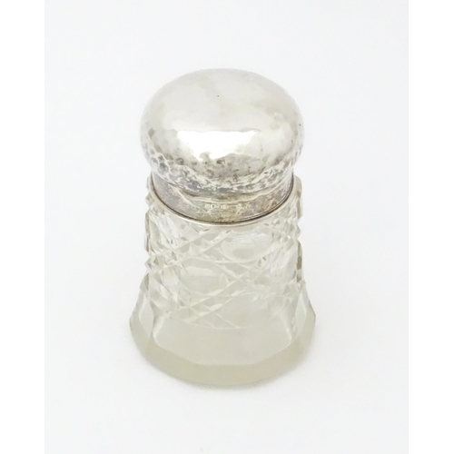 564 - A cut glass dressing table jar with hammered silver lid hallmarked Birmingham 1908, maker Walker & H... 