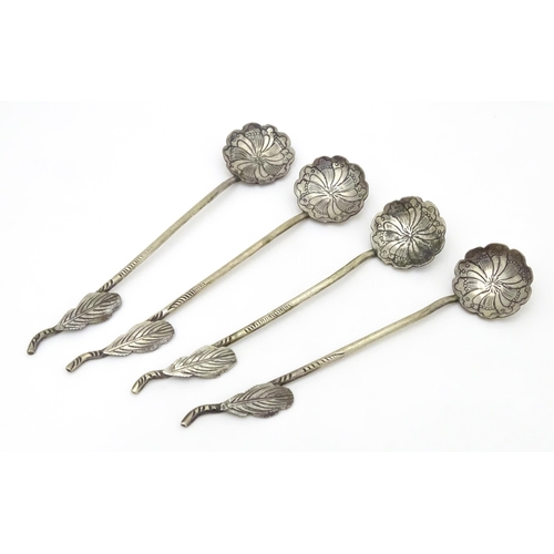 579 - A set of four Continental white metal salt spoons with floral detail to bowls and foliate handles. A... 