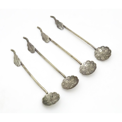 579 - A set of four Continental white metal salt spoons with floral detail to bowls and foliate handles. A... 