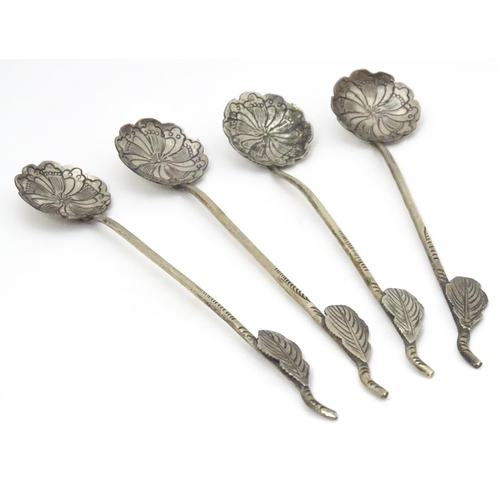 579 - A set of four Continental white metal salt spoons with floral detail to bowls and foliate handles. A... 