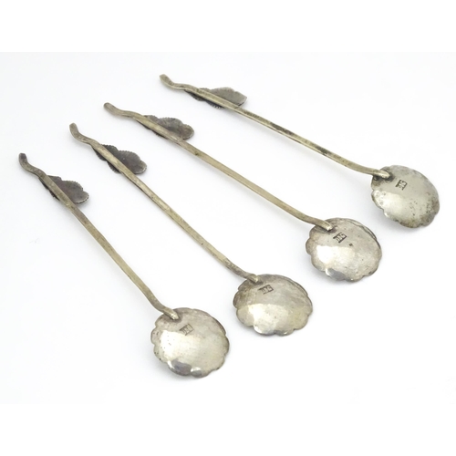 579 - A set of four Continental white metal salt spoons with floral detail to bowls and foliate handles. A... 