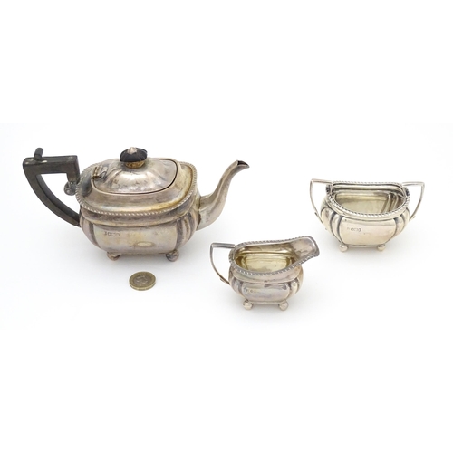 585 - A silver bachelors tea set comprising teapot, cream jug and sugar bowl, hallmarked Sheffield 1907, m... 