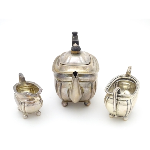 585 - A silver bachelors tea set comprising teapot, cream jug and sugar bowl, hallmarked Sheffield 1907, m... 