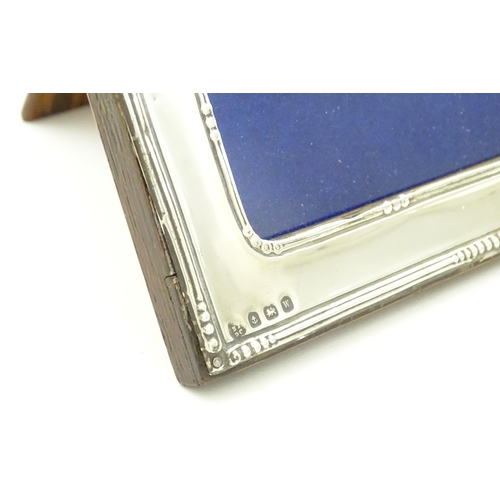 595 - A photograph frame with silver surround,  hallmarked Birmingham 1921 maker Boots Pure Drug company. ... 